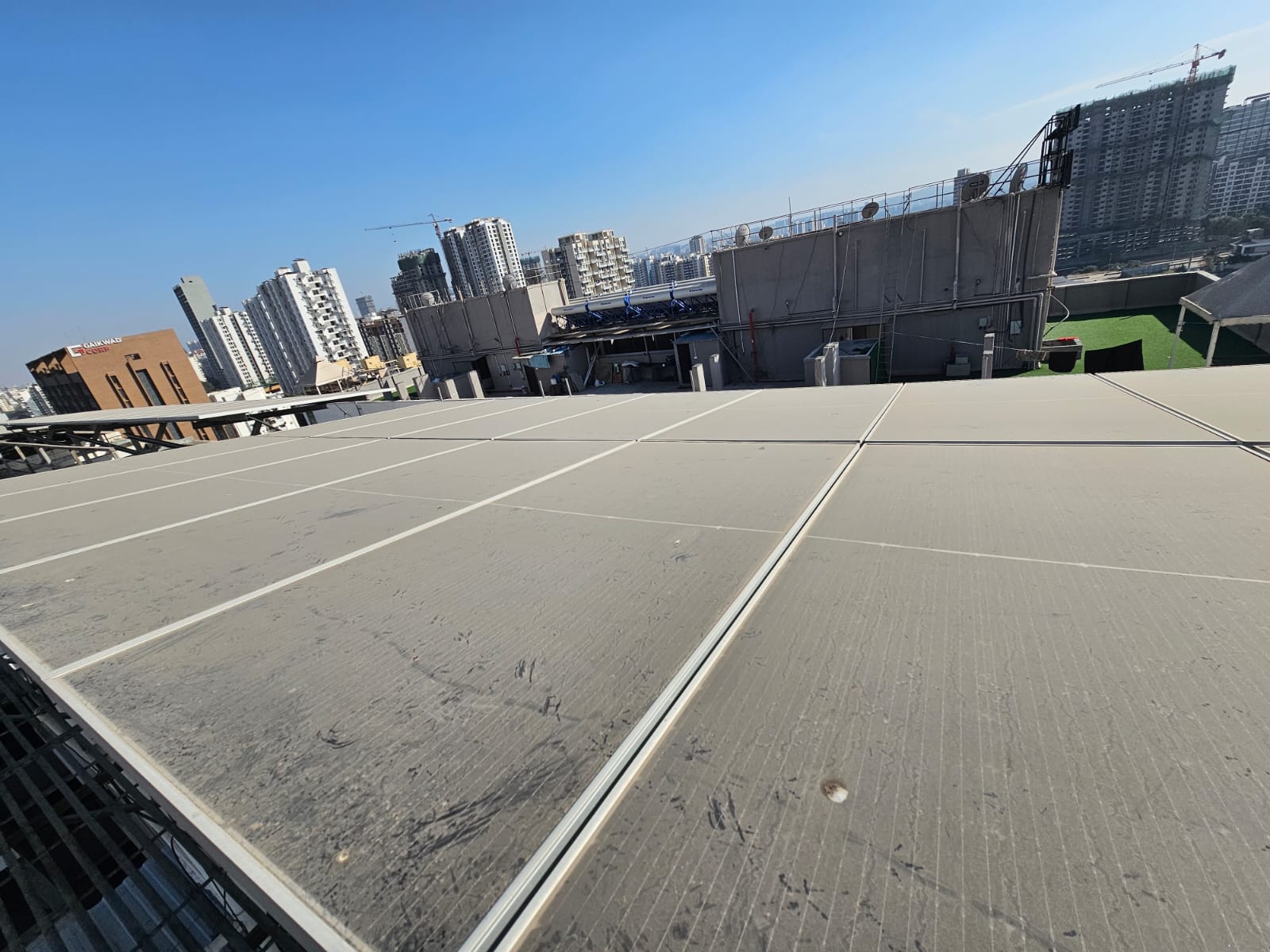 Dust-covered solar panels on a commercial rooftop